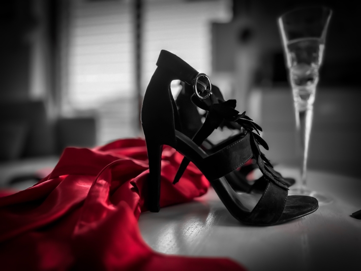 Closeup of high heels with a glass of champagne